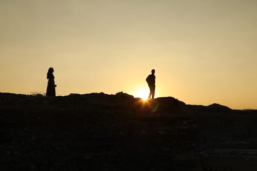 Silhouette of people on hill