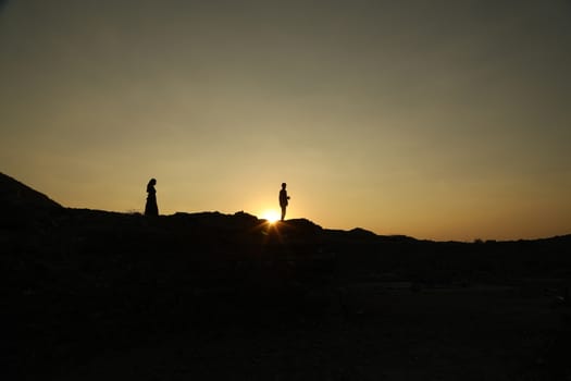 Silhouette of people on hill