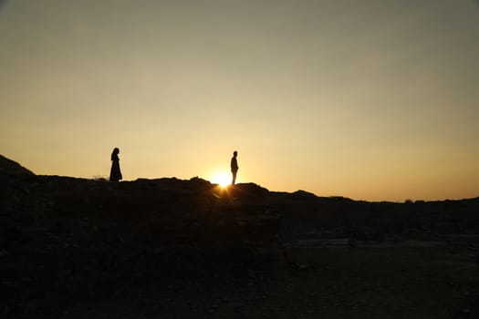 Silhouette of people on hill