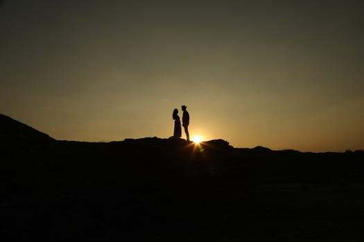 Silhouette of people on hill