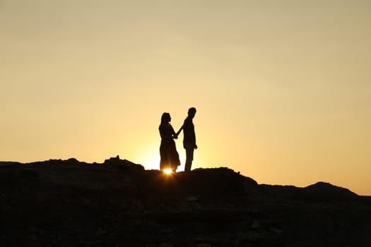 Silhouette of people on hill