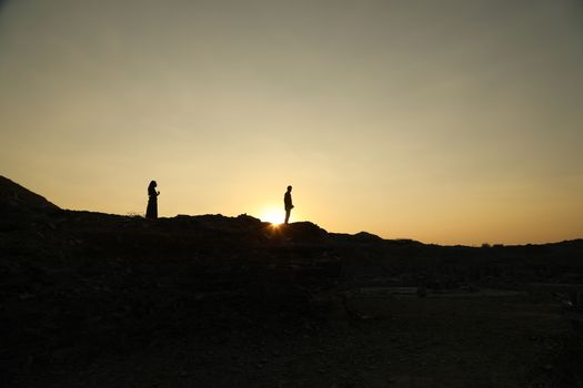 Silhouette of people on hill