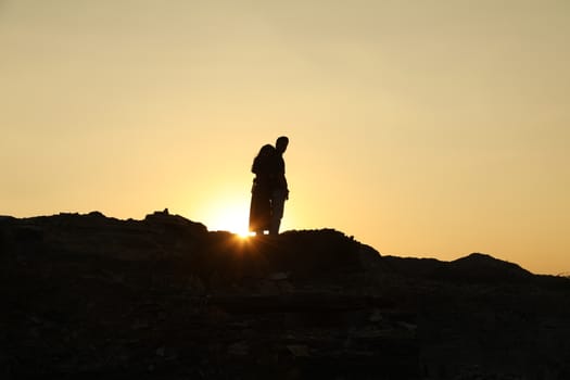 Silhouette of people on hill