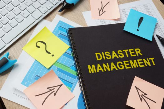 Documents about Disaster Management on a table.