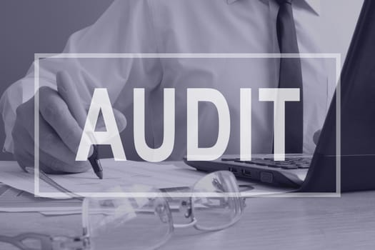 Audit concept. Auditor is working with ledger.