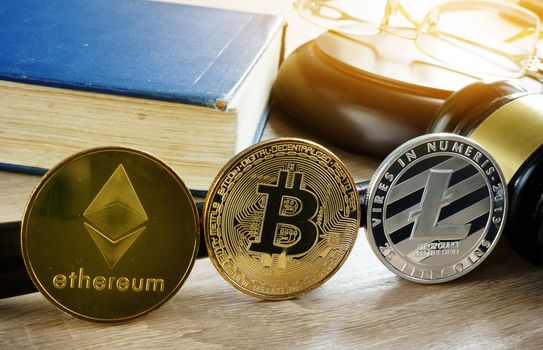 Cryptocurrency market regulation. Crypto coins and gavel on a desk.