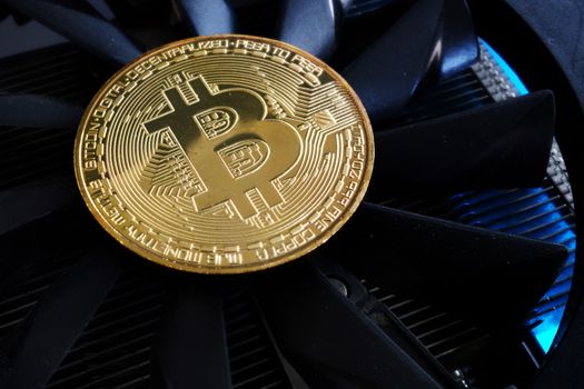 Cryptocurrency mining. Bitcoin BTC coin on a cooler.