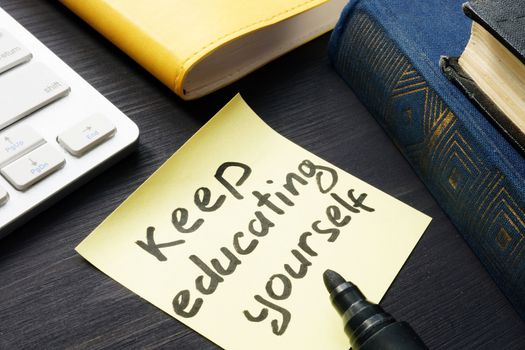 Keep educating yourself. Book and keyboard. Lifelong learning.
