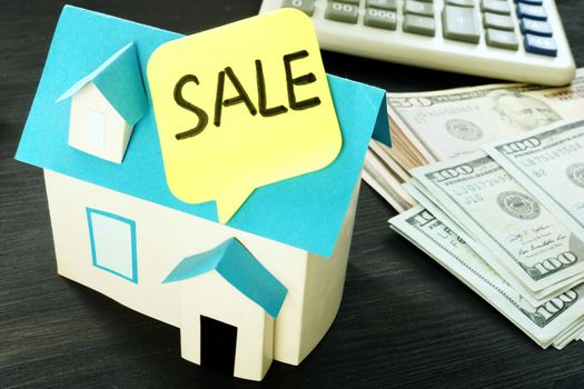 Sale home written on a model of house. Real estate concept.