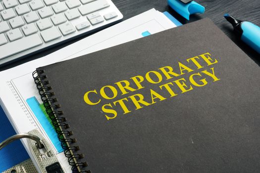 Corporate strategy plan and documents on a desk.