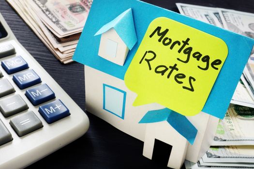 Mortgage rates written on a model of house.