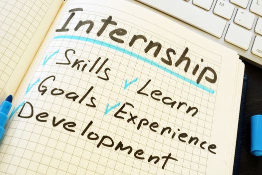 Internship and list of pros written in the notepad.