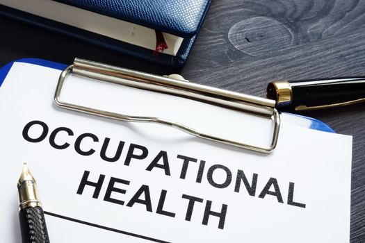 Occupational health report, pen and notepad.