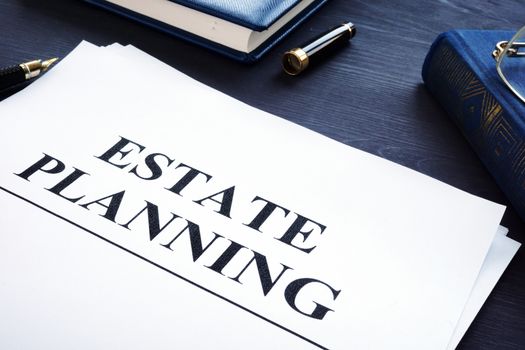 Estate planning documents on a desk. The will concept.