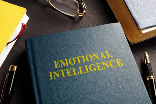 Book about Emotional intelligence EI on a desk.