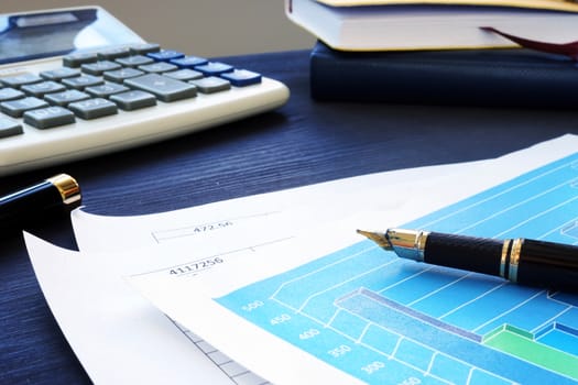 Business papers on an office desk. Financial report.