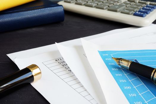 Accounting. Financial documents and charts on a desk.