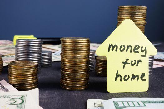 Money for home. Stacks of coins. Mortgage loan.