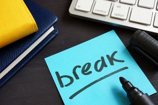 Break written on a piece of paper. Overwork and stress in business.