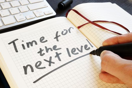 Man is writing time for the next level. Motivation.