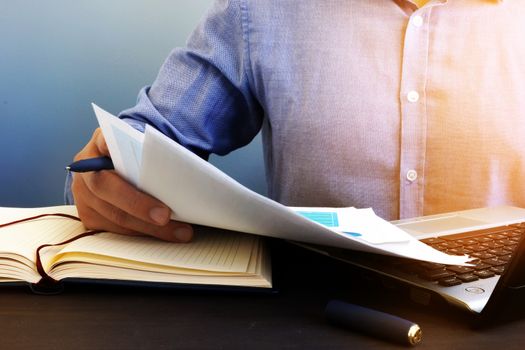 Auditor checking financial report. Paperwork in the office and audit.