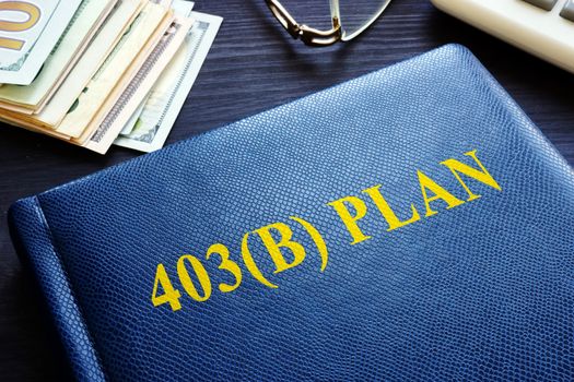 403b Plan and money on a table. Retirement.