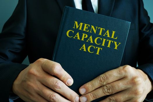 Man is holding mental capacity act.