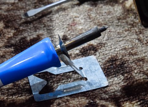 Hot soldering iron on a metal stand. radio master tools.