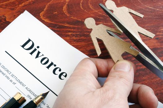 Divorce agreement form and figures of couple. Separation process.