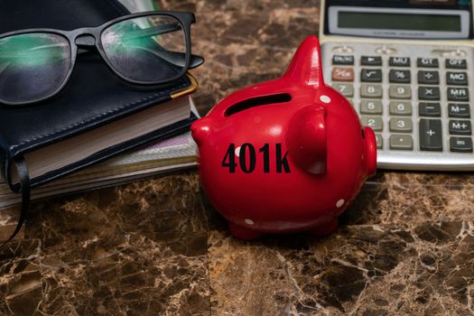 American concept of retirement savings with a piggy Bank against the background of glasses and a daily planner on a marble table