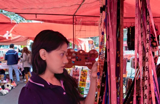 Woman buying some vegetables and fruits in a local mexican market