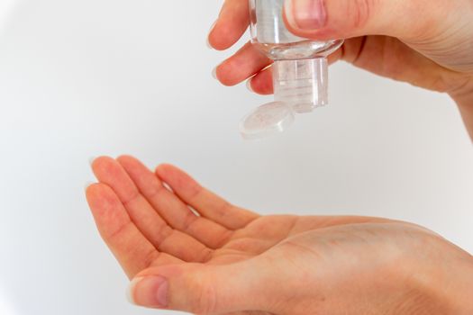 Woman washing hands with hand sanitizer alcohol antibacterial to prevent germs, bacteria and avoid coronavirus infections