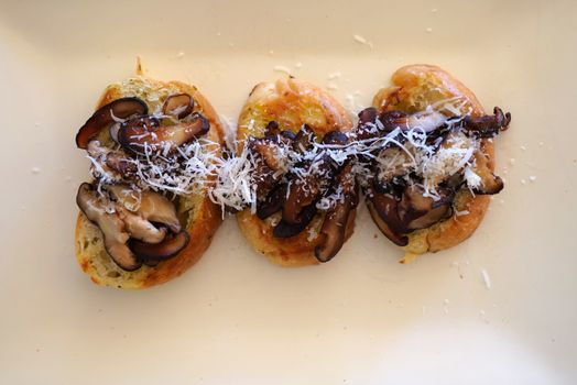 Warm Mushroom & Cheese Bruschetta on white plate.