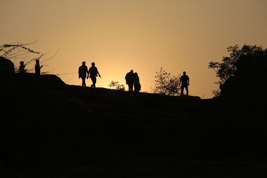 Silhouette of people on hill