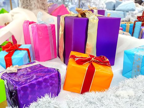 Concept image of various multicolored Christmas gifts under a Christmas tree