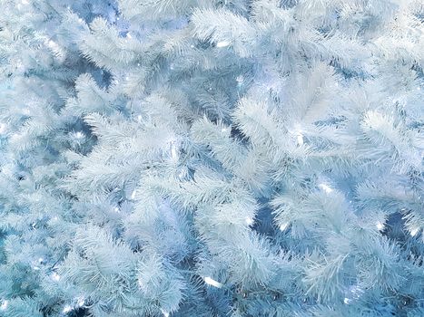 Concept of frozen and snowy trees with lights as beautiful White Christmas abstract background