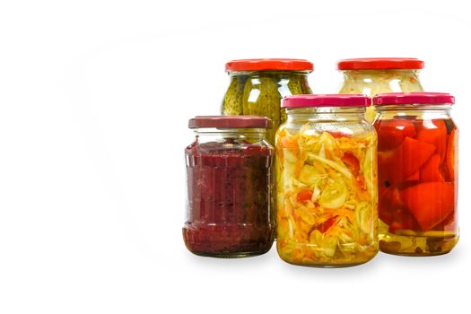 Jars with variety of homemade pickled vegetables isolated on a white background with copy space place .