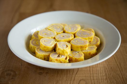 egg roll with fish paste on wooden background