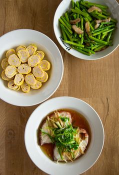 top view of various chinese food on wooden background