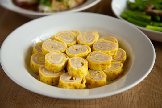 egg roll with fish paste on wooden background