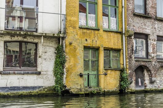 Old and colorful houses on the edge of a canal of Belgian gent