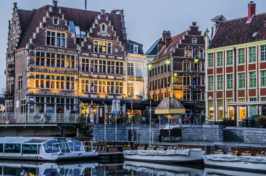 Boats pier and old buildings with its bars in ghent belgium