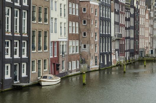 Old buildings on a canal in the center of amsterdam Holland