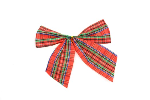 Red checkered bow on a white background in close-up