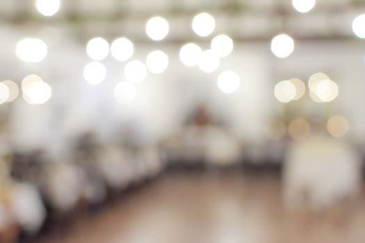 Beautifully blurred restaurant or banquet hall interior with a bokeh lights effect