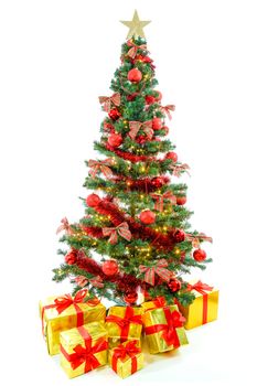 Luxury golden colored gifts with red ribbon under a beautiful, large christmas tree with red balls, bows and lights isolated on white background.
