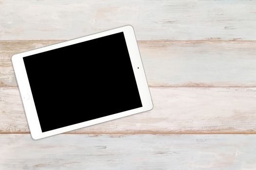 Mockup of a modern white and silver digital tablet on a wooden bright background (high angel view)