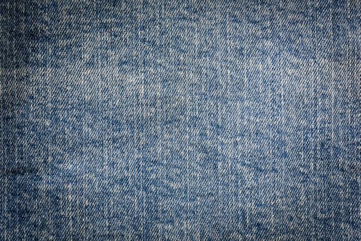 Textured vintage background - dirty blue jeans textile in close-up (high details)