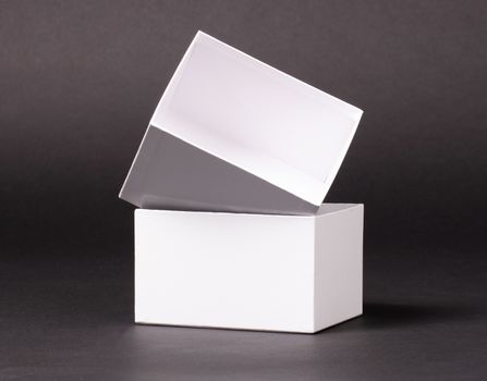 Opened blank White box isolated  on a black background