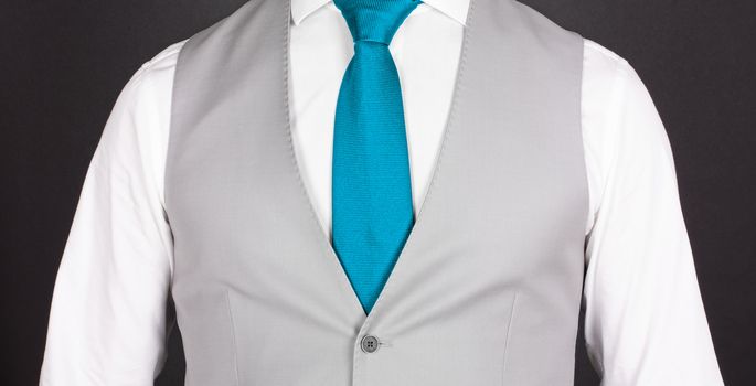 Man in a grey suit with blue tie, close-up